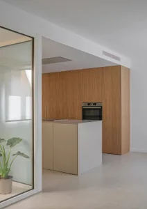 Modern minimalist kitchen featuring white and wooden materials.