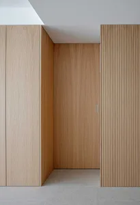 Modern minimalist interior design featuring wooden paneling and clean lines.