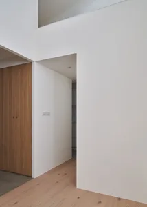 Modern minimalist entryway with white stone floor