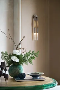 A modern interior design with a ceramic ornament, walnut wood, and steel accents. The scene features a minimalist living room