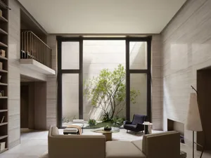 Modern living room with large windows, beige tile flooring, and minimalist furniture.
