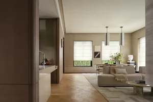 A modern living room featuring a beige sofa, a wooden coffee table, and a combination of wood and marble flooring.