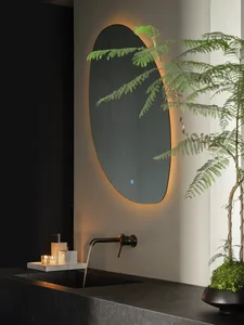 A sleek, minimalist bathroom features a modern concrete floating counter with a sink and faucet, illuminated by warm ambient 