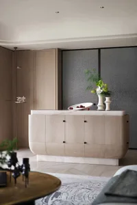 Modern living room featuring a wooden cabinet with a marble countertop, containing decorative elements like a white vase with