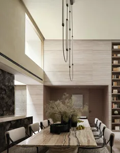 Modern dining room with marble table and chairs.