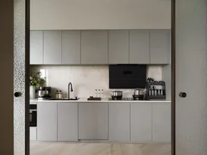 Modern, minimalist kitchen with gray oak cabinets, stainless steel appliances, and a neutral color palette.