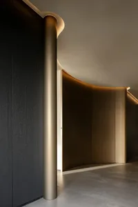 A sleek, modern entrance area featuring metallic mesh paneling and illuminated features.