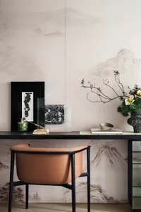A modern home office featuring a sleek desk, minimalist chair, and stylish decor.
