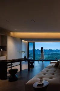 A modern living room with glass and wooden elements.