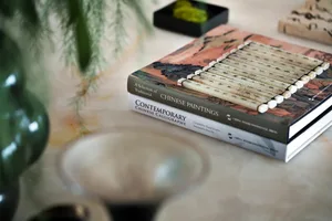 Two books with wooden design resting on a table.
