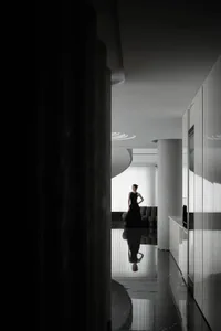 A modern apartment with glass walls and marble finishes.