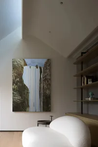 A modern living room with a large, abstract painting hanging on the wall.
