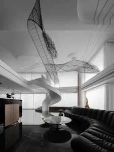 A modern living room featuring sleek black leather furniture and metal decorative elements.