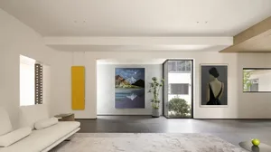 A modern minimalist living room with concrete flooring and wooden accents.