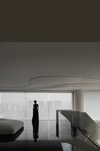 A sleek, minimalist living room with glass walls and steel accents.