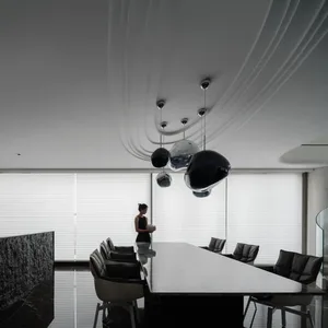 A modern, minimalist office space featuring glass, concrete, and steel elements.