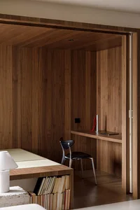 Modern minimalist office space featuring wood paneling and furniture.