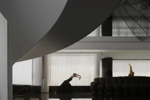 A modern living room with metal, glass, and concrete materials
