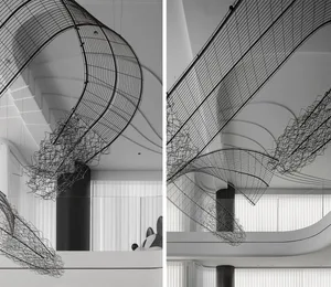 Modern interior design featuring metal netting hanging from the ceiling.