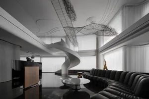 Modern living room with black leather seating, metal accents, and white marble flooring.