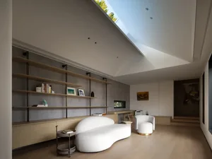 A modern living room with wooden walls and white textile furniture.