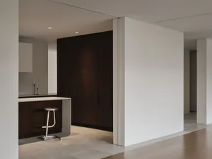 Modern minimalist kitchen featuring dark wood cabinetry and concrete countertops.