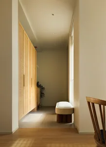 A minimalist interior with wooden furniture and doors.