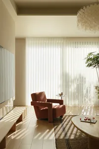 Modern living room featuring curtains fabric and a cozy armchair.