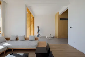 A modern living room with minimalist design and wooden finishes.