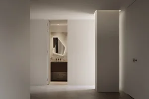 Minimalist bathroom with tiled walls and floor, featuring a sleek, contemporary design.