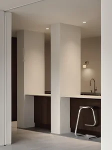 A modern minimalist kitchen with wooden cabinets, white countertops, and a sleek, contemporary design.