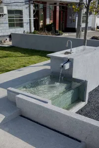 Concrete modern water feature with a running fountain.