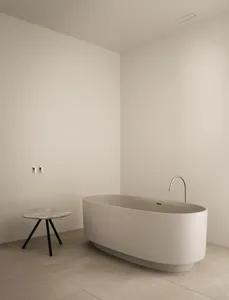 A modern, minimalist bathroom renovation showcasing sleek, white fixtures, clean lines, and an overall airy feel.