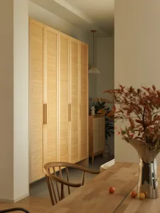A modern interior design featuring wooden cabinets in a living room setting.