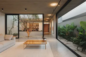 Modern minimalist living room with concrete floor and glass wall