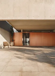 Modern residential interior with concrete walls and floors.