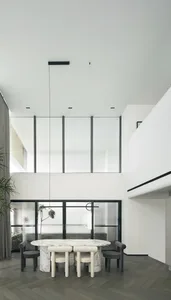 Modern dining room with a marble table and minimalist design.