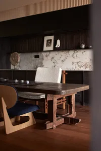 Wooden dining table with marble accents in a modern residential setting.