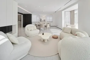 A modern living room with neutral-toned furniture and a minimalist aesthetic.