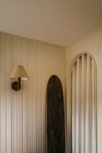 A minimalist interior design featuring wooden elements and white walls.