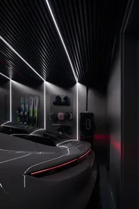 A sleek, modern garage interior with black metal walls and ceiling features.