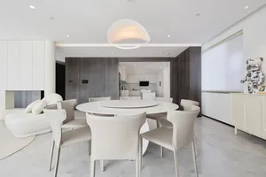 Modern interior living room featuring a white marble dining table and chairs