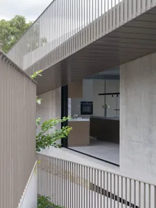 Modern kitchen interior with concrete elements and minimalist design.