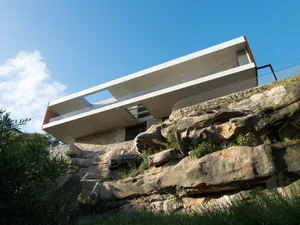 A modern residential architecture building with concrete and glass materials.