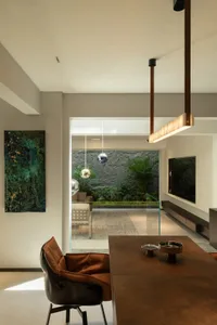 Contemporary living room featuring modern concrete walls, glass elements, and leather seating.