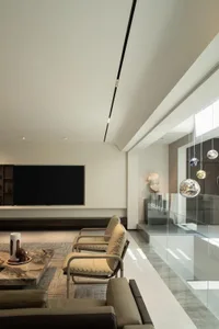 Contemporary living room with marble accents and minimalist furniture.