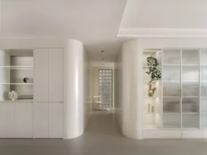 A minimalist interior featuring concrete and glass materials.