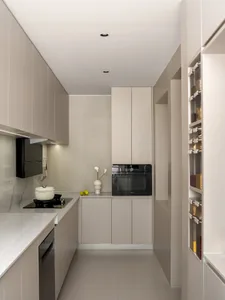 A modern, minimalist kitchen with concrete countertops and cabinets, featuring sleek appliances and a clean, uncluttered desi