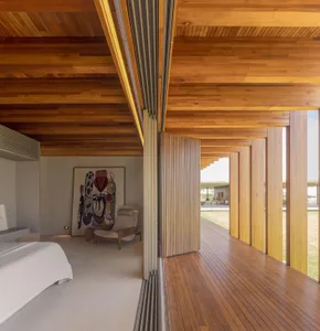 A modern interior space featuring minimalist design and wooden elements, with a focus on natural light and open layout.