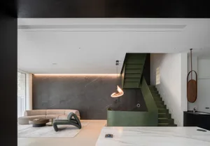 Modern living room featuring a concrete wall and marble table and floor.